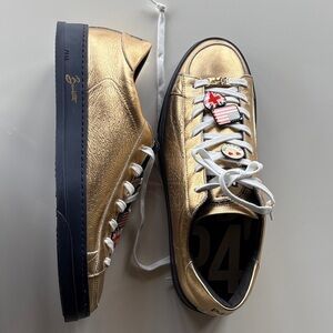 P448 x Bombette collaboration in metallic gold with black sole and charms.